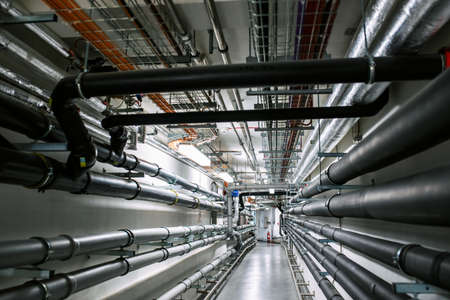 Laying of engineering networks. Ventilation pipes. Air conditioning of buildings. Pipe installation. Technical floor. Maintenance of cable networks.の写真素材