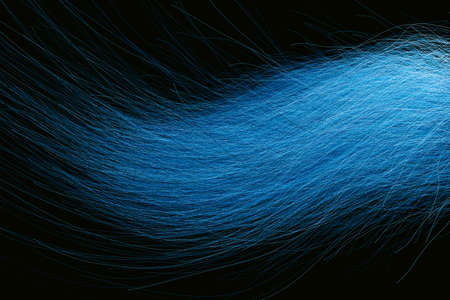 3D rendering of a closeup view of a bunch of blue hair in a wavy curved style, dark abstract backgroundの写真素材