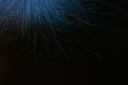 3D rendering of a closeup view of a bunch of blue hair in a wavy curved style, dark abstract backgroundの写真素材