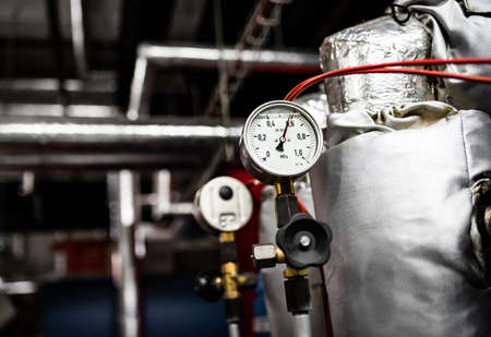 Barometers on pressure pipes, technical room with heat and water distributionの写真素材