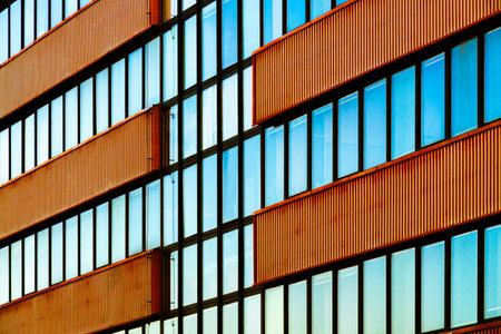 Modern Building Facade with Vertical Metal Panels and Reflective Glass Windows