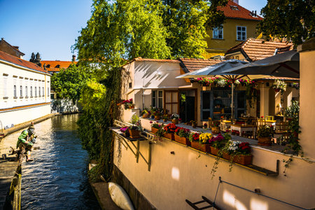 Picturesque Canal-Side Cafe with Flowers in Prague's Historic Old Town, Prague, MalÃ¡ Stranaの写真素材
