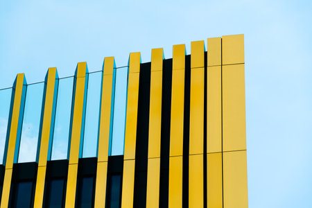 Modern Architectural Facade with Dynamic Curves and Reflective Glass Panelsの写真素材