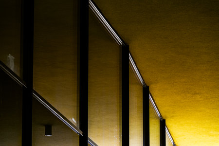 Abstract View of Modern Architecture with Bold Yellow Walls and Reflective Glass Panelsの写真素材