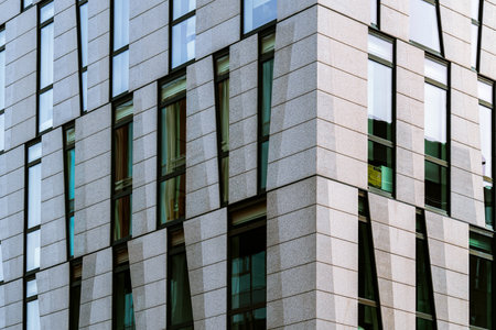 Contemporary Office Building Facade with Vertical Panels and Large Glass Windows