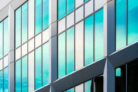 Modern Glass Facade with Reflective Panels and Angular Architectural Details in Urban Design