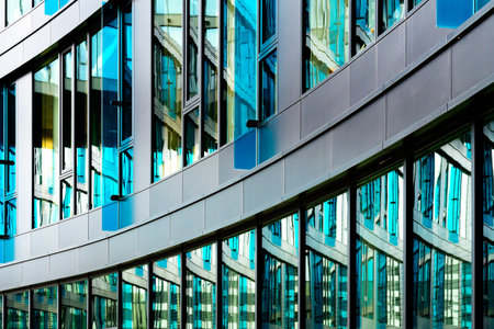 Modern Glass Office Building with Blue-Tinted Windows and Sleek Architectural Design