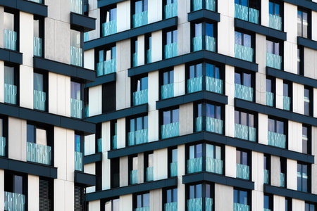 High-density residential building with white and black grid and vertical balconies