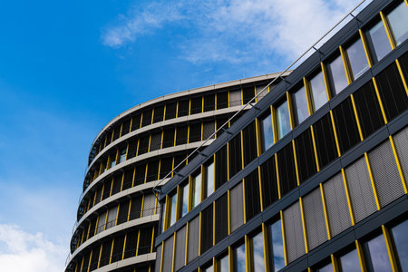 Corporate facade with gold-toned frames and rhythmic window layout