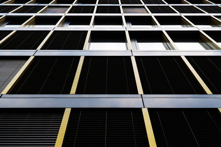 Corporate facade with gold-toned frames and rhythmic window layout