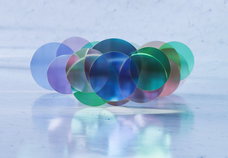 3D rendering of Stacked Transparent Glass Discs with Iridescent Edges on Marble Floor in Soft...