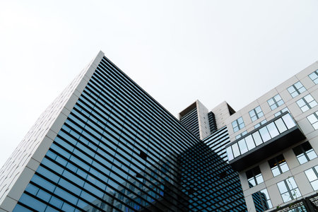 Contemporary corporate office building with glass and steel facade featuring modern geometric lines...
