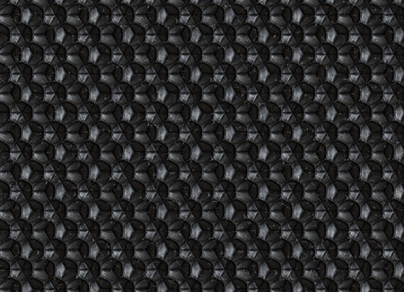 Decorative architectural surface composed of interlocking tiles made of black marble. The design...