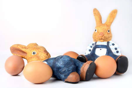 Two easter bunnies sitting among eggsの写真素材