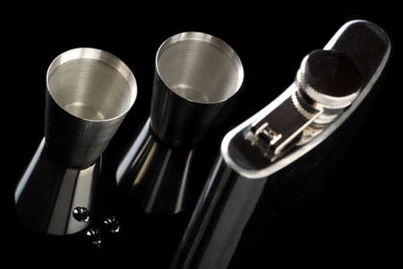 Flask of brandy isolated over a black backgroundの写真素材