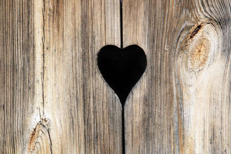 Detail of a wooden door with heart decorationの写真素材