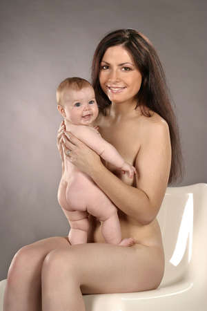 auburn haired girl, woman with baby-smilingの写真素材