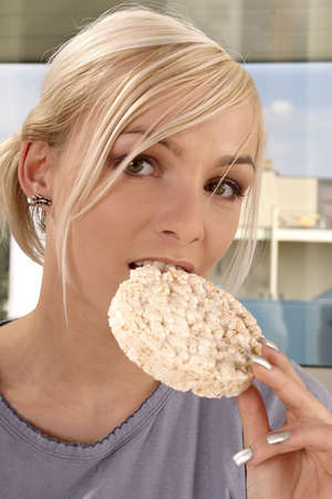 blond, young girl, woman eating rice cracker