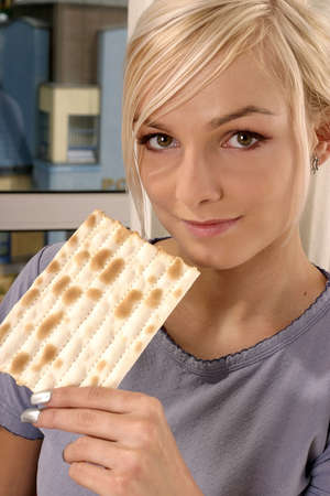 blond, young girl, woman eating unleavened breadの写真素材