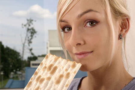 blond, young girl, woman eating unleavened breadの写真素材