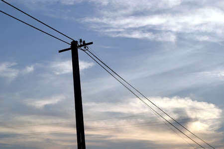silhouette of  pylon tower in country during fiery sunsetの写真素材