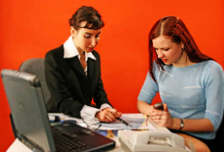 two young woman discuss over a blueprint -isolated の写真素材