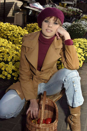 Fashion friendly girl in a hat portrait outdoor with  a basketの写真素材