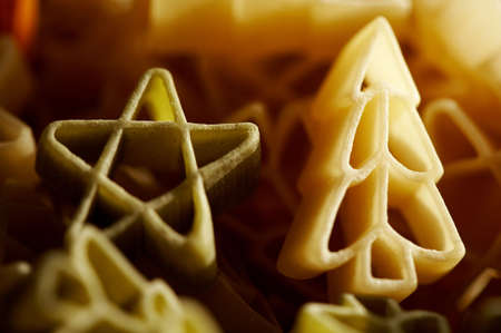 Colourfull christmas decorations- stars and trees made from pasta in close up. の写真素材