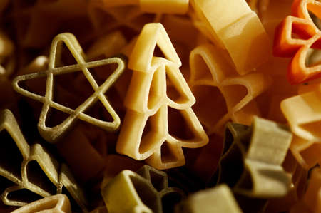 Colourfull christmas decorations- stars and trees made from pasta in close up. の写真素材