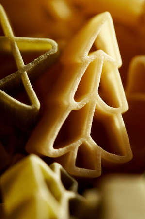 Colourfull christmas decorations- stars and trees made from pasta in close up. の写真素材