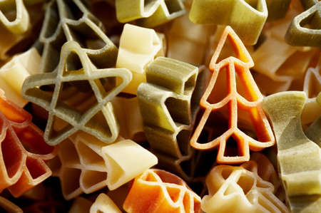 Colourfull christmas decorations- stars and trees made from pasta in close up. の写真素材