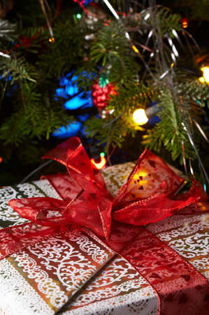 Christmas gifts under the christmas tree with a red ribbon.の写真素材