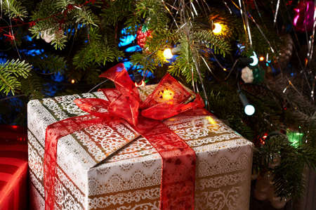 Christmas gifts under the christmas tree with a red ribbon.の写真素材