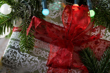 Christmas gifts under the christmas tree with a red ribbon.の写真素材