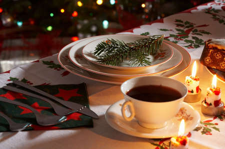 Christmas traditionally decorated table with a cup of borsch with candels.の写真素材