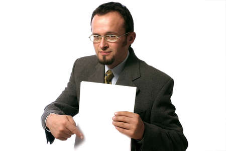 Young handsome  businessman pointing to a blank sheet of paper.の写真素材