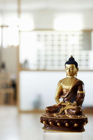 Golden and brown statue of buddha - shallow focus, on a blured background. の写真素材