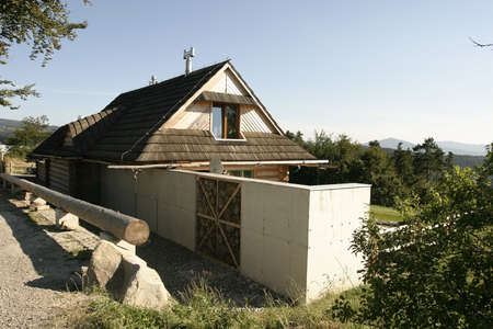 Rustic wooden house in a touristic mountainous area on sunz day.の写真素材