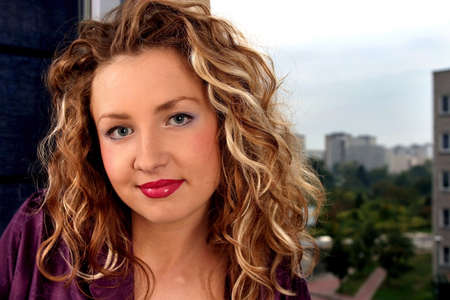 Young beautiful blonde woman with curly hair smiling.の写真素材