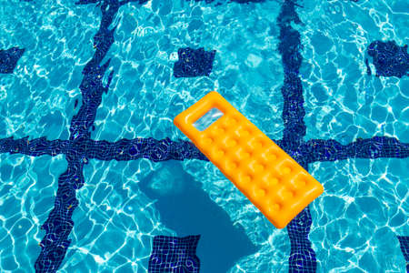 Orange inflatable mattress in the pool. Top viewの写真素材
