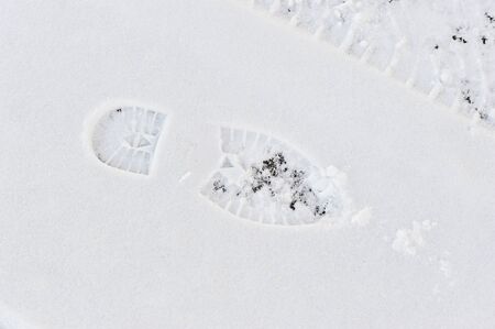abstract - the trail tread of boots on snowの写真素材