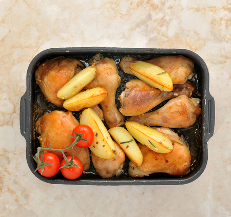 roast chicken with potatoes and cherry tomatoes. top viewの写真素材