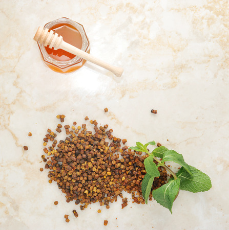Ambrosia - a waste product of bees and honey with a stick of honey. top view