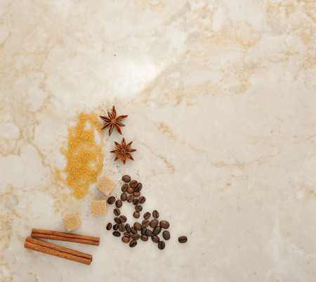 coffee, cane sugar, spice anise and cinnamon on a marble background. top view. copy spaceの写真素材