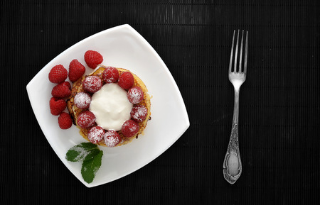 dessert of pancakes with raspberries and sour cream. top viewの写真素材