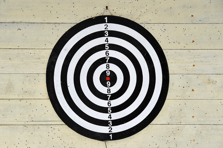 dartboard on a light yellow background with traces of Dartsの写真素材