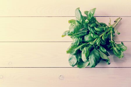 bunch of spinach on a white wooden background. top view. copyspace