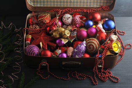 Vintage suitcase with festive Christmas decorations for the Christmas tree - star, beads, toys - top viewの写真素材