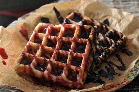 two Belgian waffles with raspberry jam and chocolate