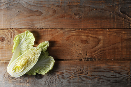 Fresh half Head Chinese salad (Peking, pe-tsai) cabbage on a wooden rustic background. top view. flat layer; copy spaceの写真素材